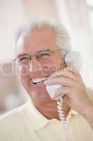 Man using telephone and smiling