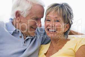 Couple relaxing in living room and smiling