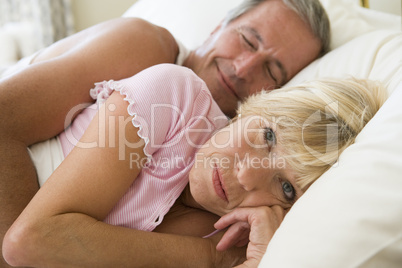 Couple lying in bed together