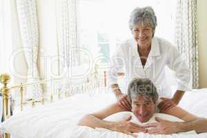 Man receiving a massage from a woman