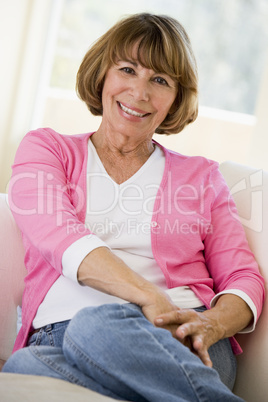 Woman sitting in living room smiling