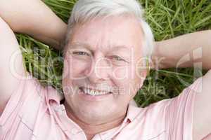 Man lying in grass smiling