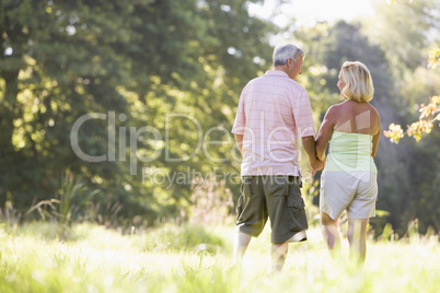 Couple walking in park holding hands