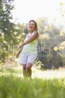 Woman walking outdoors smiling