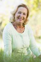 Woman sitting outdoors smiling