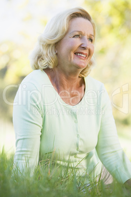 Woman sitting outdoors smiling