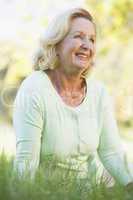 Woman sitting outdoors smiling