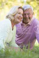 Couple relaxing in park smiling