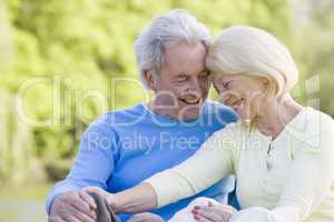 Couple outdoors laughing