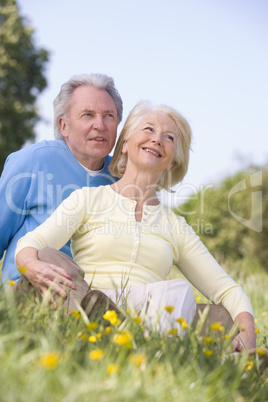 Couple relaxing outdoors smiling