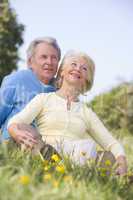 Couple relaxing outdoors smiling