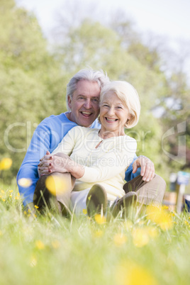 Couple relaxing outdoors smiling