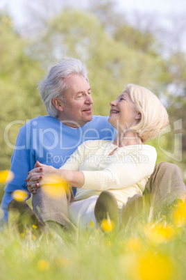 Couple relaxing outdoors smiling