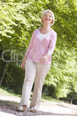 Woman walking outdoors smiling