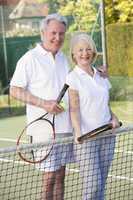 Couple playing tennis and smiling