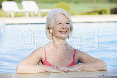 Woman in outdoor pool smiling