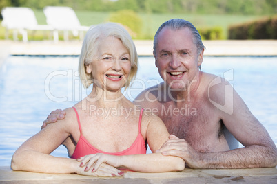 Couple in outdoor pool smiling