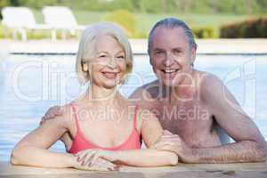 Couple in outdoor pool smiling