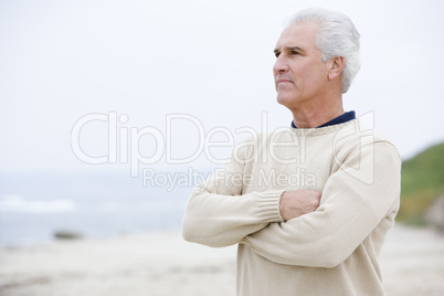 Man at the beach with arms crossed