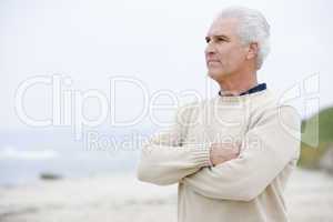 Man at the beach with arms crossed