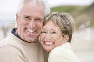 Couple at the beach smiling