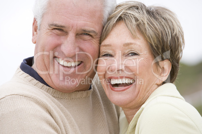 Couple at the beach smiling