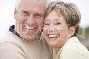 Couple at the beach smiling