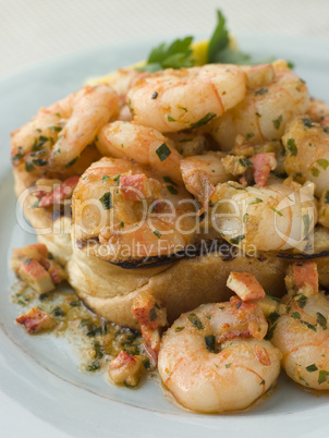 Toasted Brioche topped with Prawns cooked In Lobster Garlic Butt