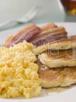 American Pancakes with Crispy Bacon and Scrambled Eggs and Maple
