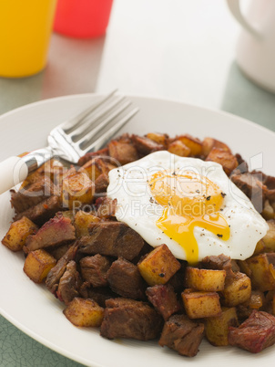 Corned Beef Hash with a Broken Fried Egg and Black Pepper