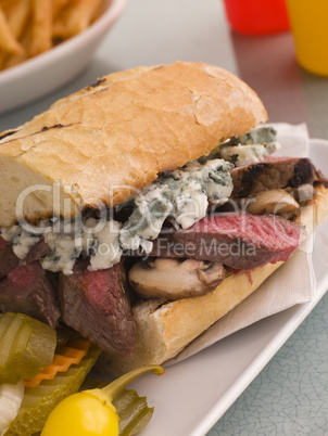 Steak and Roquefort Sandwich with Fries Gherkins and Chillies