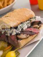 Steak and Roquefort Sandwich with Fries Gherkins and Chillies