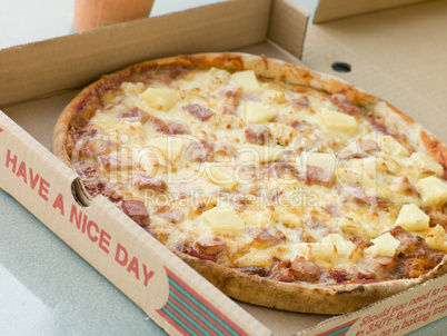 Ham and Pineapple Pizza in a Take Away Box