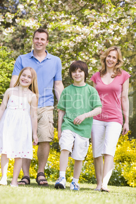 Family walking outdoors smiling