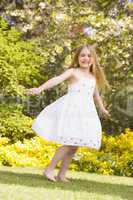 Young girl standing outdoors smiling