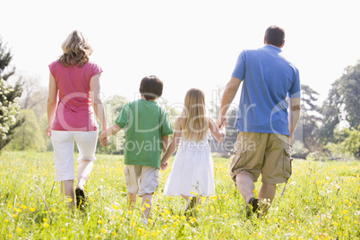 Family walking outdoors holding hands