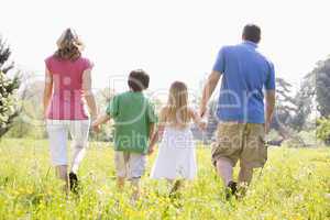 Family walking outdoors holding hands