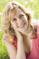 Woman sitting outdoors smiling