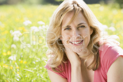 Woman sitting outdoors smiling