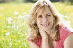 Woman sitting outdoors smiling