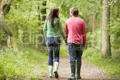 Couple walking on path holding hands