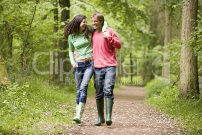 Couple walking on path arm in arm