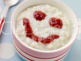 Bowl of Creamed Rice Pudding with a Strawberry Jam Face