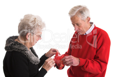 Elderly couple giving presents