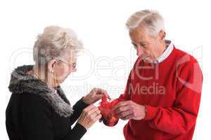 Elderly couple giving presents