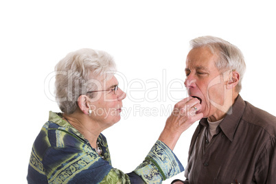 Putting a chocolate in his mouth