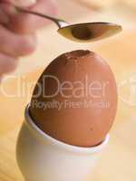 Boiled Egg being cracked open with a spoon