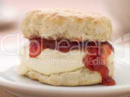 Scone Filled with Strawberry Jam and Clotted Cream on a plate