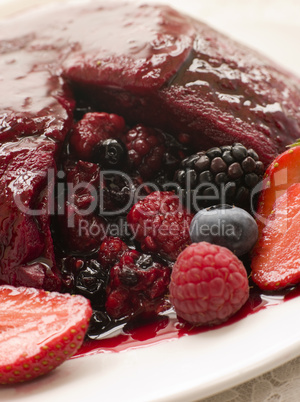 Traditional Summer Pudding with a scoop out