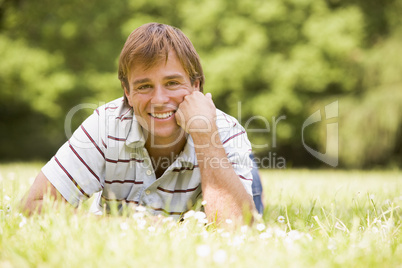 Man lying outdoors smiling